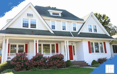 A modern two-story home with a well-manicured lawn, large windows, and a welcoming front porch, showcasing excellent curb appeal.