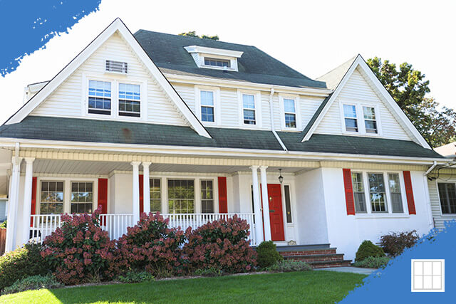 A modern two-story home with a well-manicured lawn, large windows, and a welcoming front porch, showcasing excellent curb appeal.