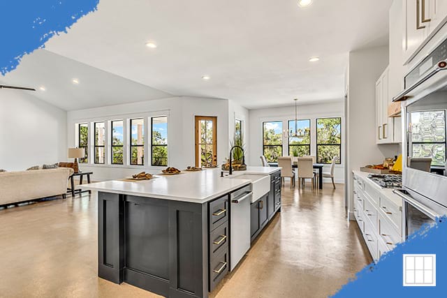 Modern kitchen in a Cass County home featuring white cabinets, stainless steel appliances, and a spacious layout.